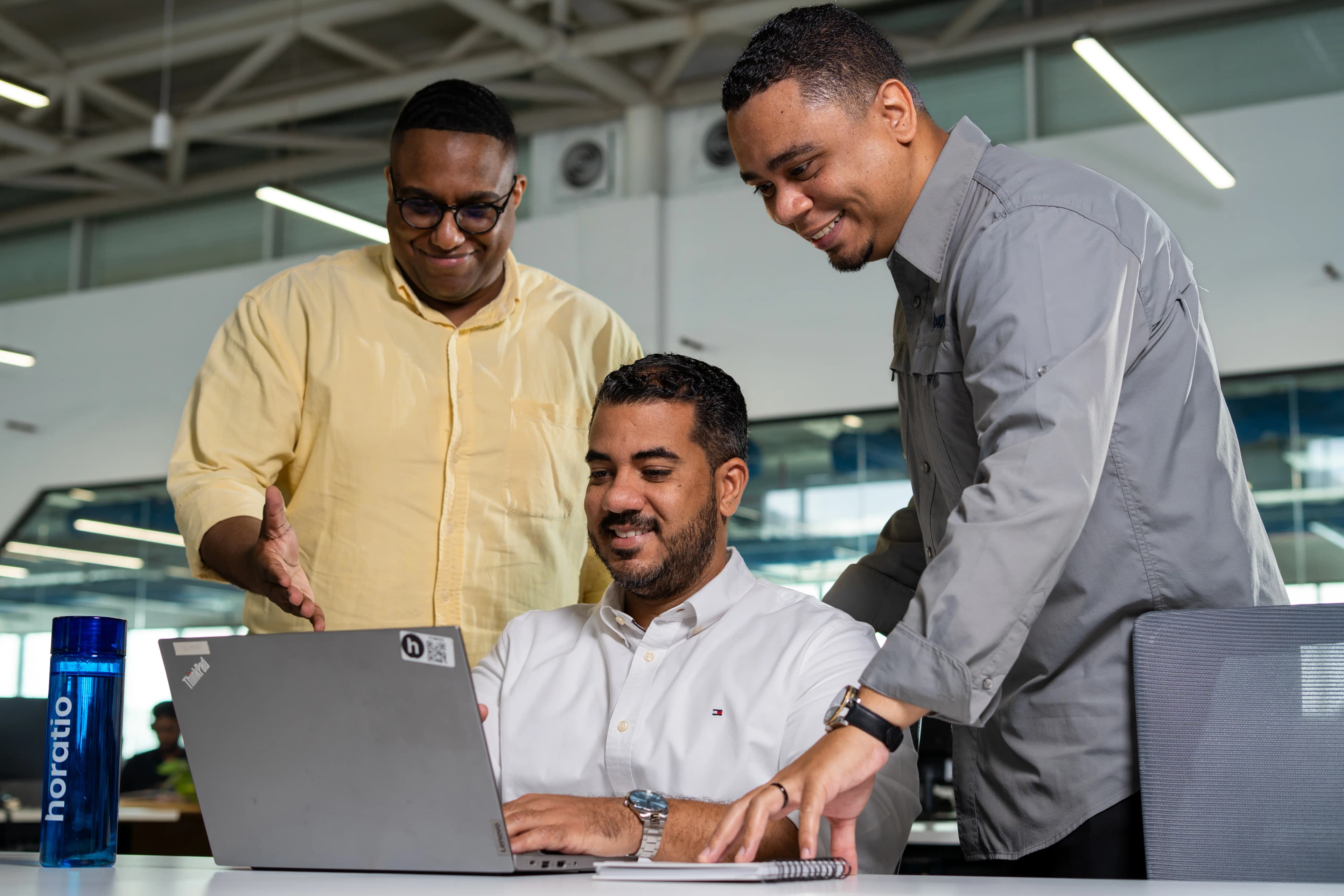 Horatio team collaborating around a laptop